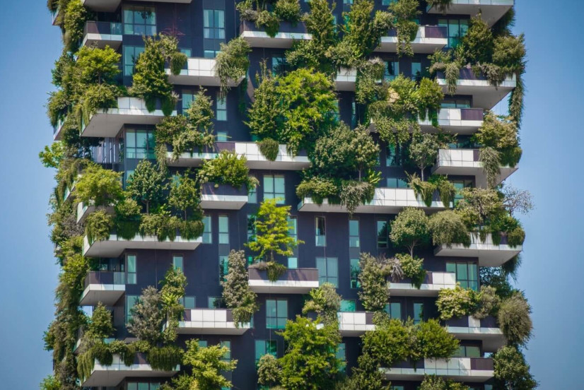 A high-rise building with a green façade