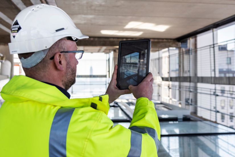 image of a construction site worker using a tablet device